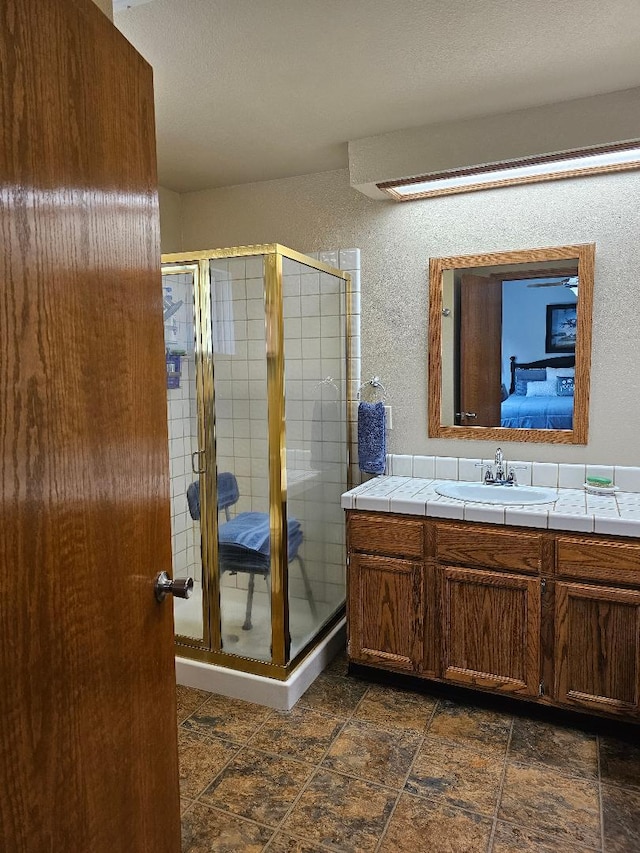 1509 Princeton Ave, Madera, CA 93637 - bathroom with vanity, a textured wall, and a stall shower