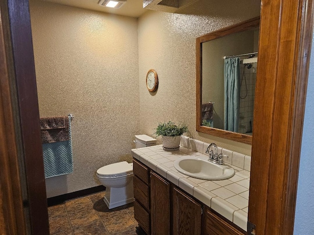 1509 Princeton Ave, Madera, CA 93637 - full bathroom with a textured wall, vanity, a shower with curtain, and stone finish flooring