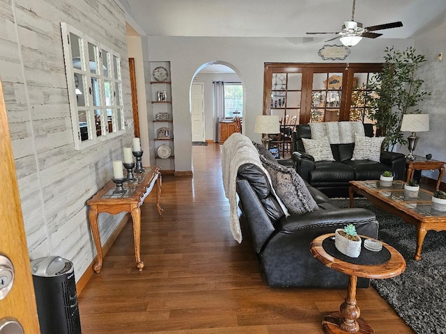 1509 Princeton Ave, Madera, CA 93637 - living room featuring arched walkways, wood finished floors, ceiling fan, and built in shelves