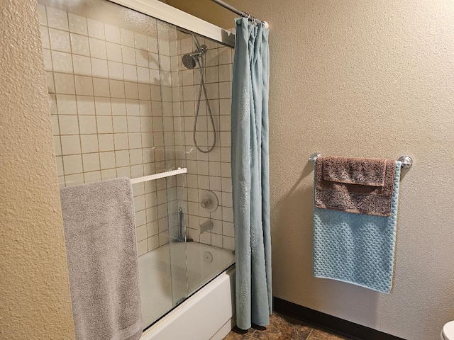 1509 Princeton Ave, Madera, CA 93637 - bathroom featuring shower / bath combo with shower curtain and a textured wall