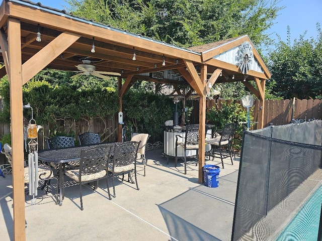 1509 Princeton Ave, Madera, CA 93637 - fenced backyard featuring a gazebo, outdoor dining area, ceiling fan, and a patio area