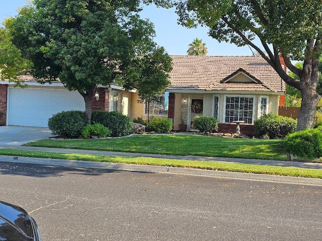 1509 Princeton Ave, Madera, CA 93637 - view of front facade with brick siding, driveway, a tiled roof, and an attached garage