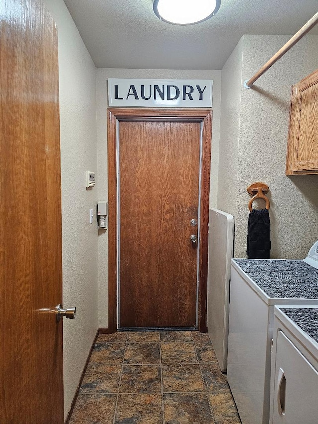 1509 Princeton Ave, Madera, CA 93637 - laundry area with washing machine and clothes dryer, cabinet space, dark stone finish flooring, and a textured wall