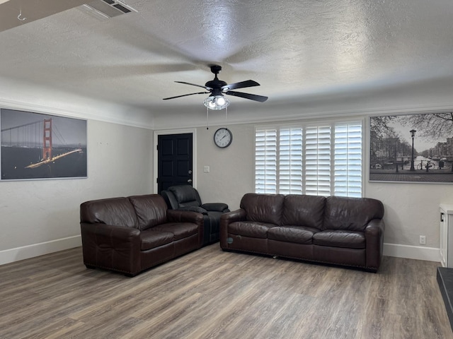 4741 W Mckinley Ave, Fresno, CA 93722 - living area featuring a textured ceiling, wood finished floors, and ceiling fan