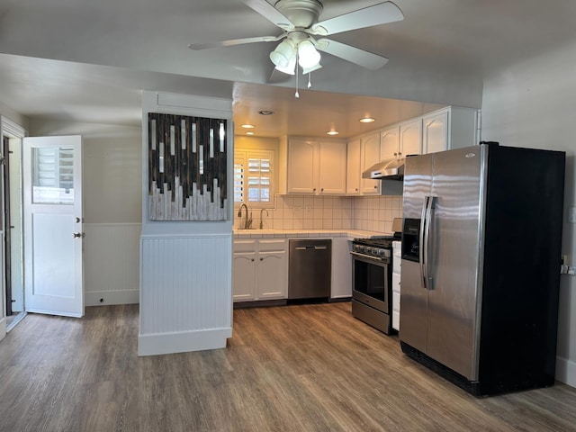 4741 W Mckinley Ave, Fresno, CA 93722 - kitchen with stainless steel appliances, dark wood-style flooring, white cabinets, ceiling fan, and tile counters