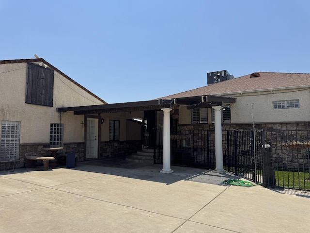 4741 W Mckinley Ave, Fresno, CA 93722 - back of house featuring stone siding and stucco siding