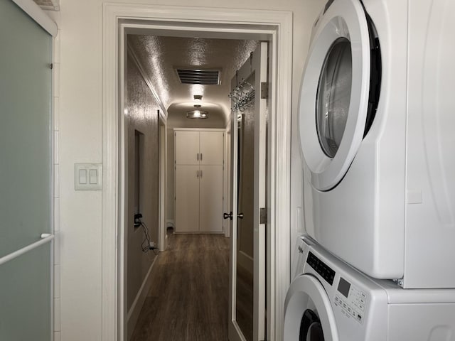 4741 W Mckinley Ave, Fresno, CA 93722 - laundry room with stacked washer / drying machine and dark wood finished floors