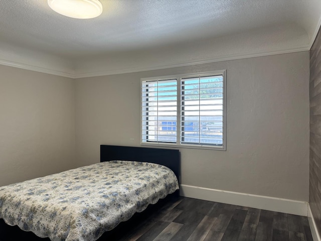 4741 W Mckinley Ave, Fresno, CA 93722 - bedroom with dark wood finished floors, a textured ceiling, and ornamental molding