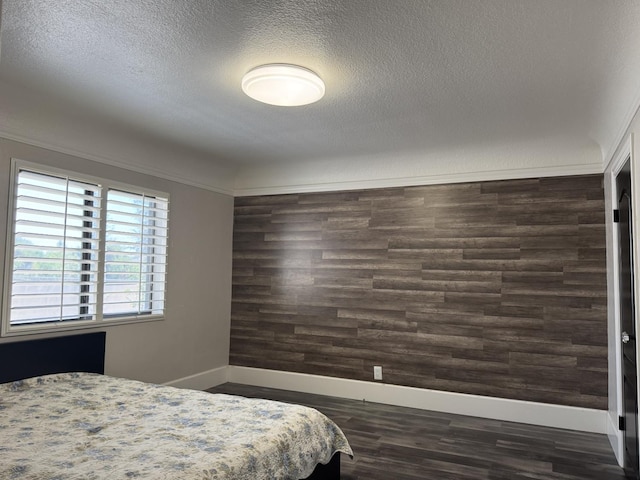 4741 W Mckinley Ave, Fresno, CA 93722 - bedroom featuring a textured ceiling and dark wood-style flooring