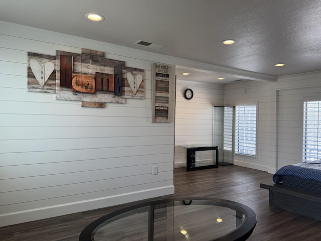 4741 W Mckinley Ave, Fresno, CA 93722 - bedroom with wood finished floors, a textured ceiling, recessed lighting, and wooden walls