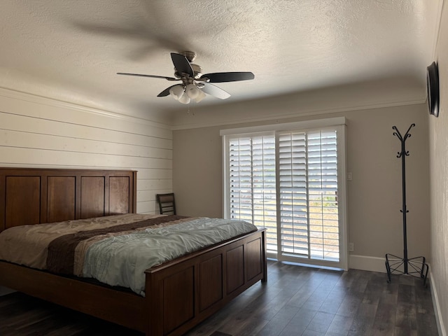 4741 W Mckinley Ave, Fresno, CA 93722 - bedroom featuring dark wood-style floors, access to exterior, a textured ceiling, and a ceiling fan