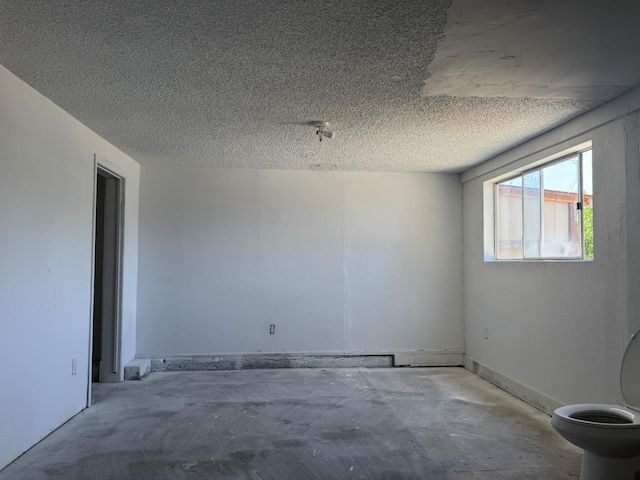 4741 W Mckinley Ave, Fresno, CA 93722 - empty room featuring concrete flooring and a textured ceiling