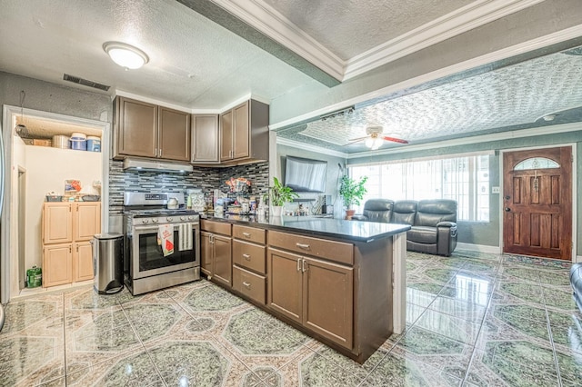 2323 E University, Fresno, CA 93703 - kitchen featuring a peninsula, stainless steel gas range oven, ornamental molding, tasteful backsplash, and a textured ceiling