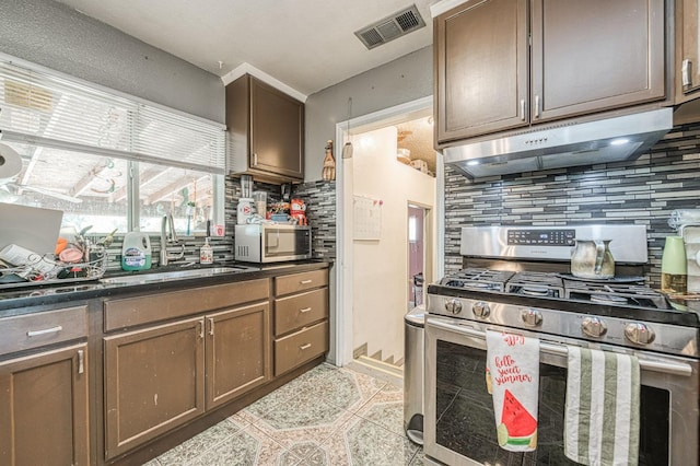 2323 E University, Fresno, CA 93703 - kitchen with stainless steel appliances, decorative backsplash, exhaust hood, and dark countertops