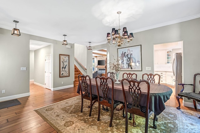 6609 N Dover Ct, Fresno, CA 93711 - dining room with stairs, crown molding, hardwood / wood-style floors, and a chandelier