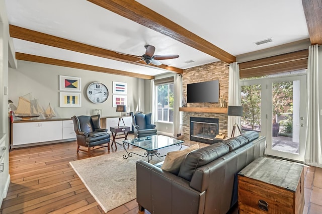6609 N Dover Ct, Fresno, CA 93711 - living room with beamed ceiling, a stone fireplace, light wood finished floors, and a ceiling fan