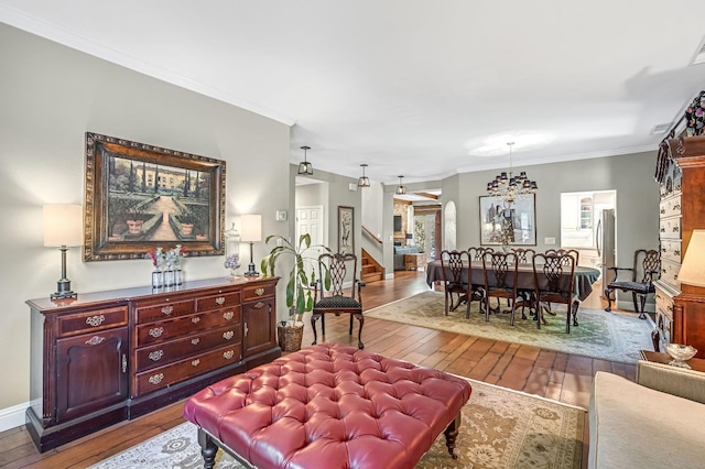 6609 N Dover Ct, Fresno, CA 93711 - living area featuring wood-type flooring, stairway, and crown molding