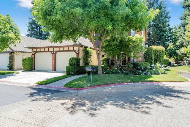 6609 N Dover Ct, Fresno, CA 93711 - view of front of home featuring an attached garage, driveway, a front lawn, brick siding, and stucco siding