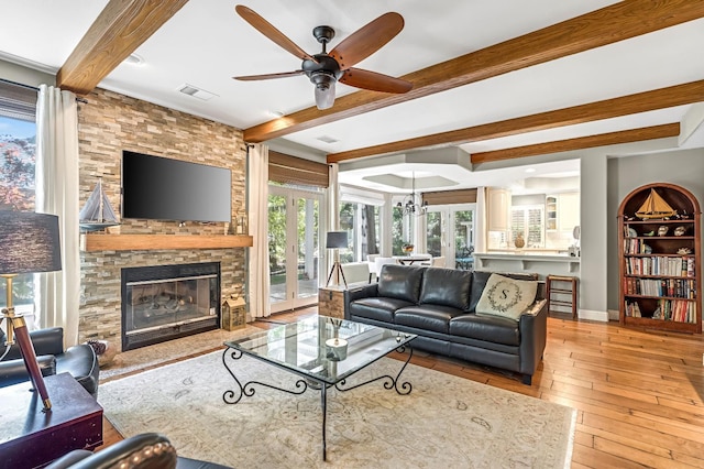6609 N Dover Ct, Fresno, CA 93711 - living area with beam ceiling, ceiling fan, a stone fireplace, and wood-type flooring