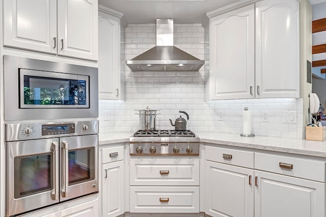 6609 N Dover Ct, Fresno, CA 93711 - kitchen with appliances with stainless steel finishes, wall chimney exhaust hood, white cabinets, and decorative backsplash