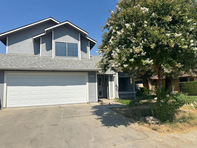 2244 N Prospect, Fresno, CA 93722 - view of front facade with concrete driveway, roof with shingles, and a garage