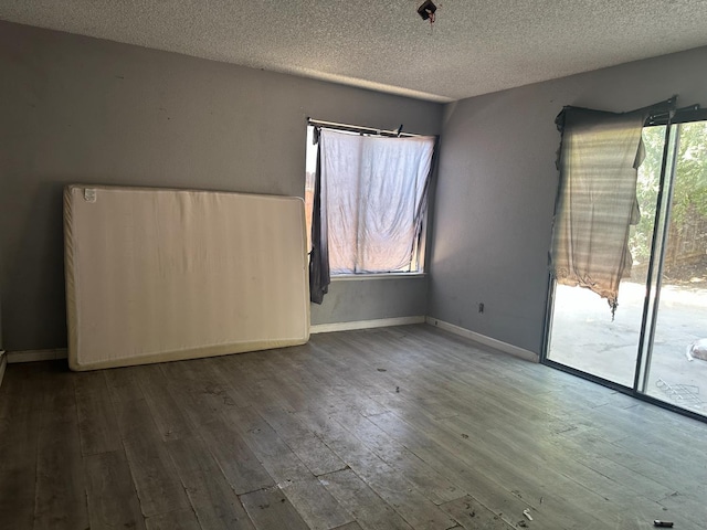 2244 N Prospect, Fresno, CA 93722 - empty room with a textured ceiling, plenty of natural light, and hardwood / wood-style floors