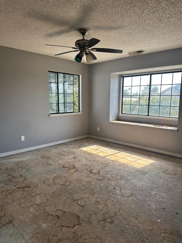 2244 N Prospect, Fresno, CA 93722 - empty room featuring healthy amount of natural light, ceiling fan, and a textured ceiling