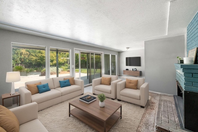 1556 E Loftus Ln, Fresno, CA 93710 - living area featuring plenty of natural light, a textured ceiling, and a fireplace with raised hearth