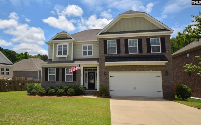 craftsman house with a front lawn and a garage