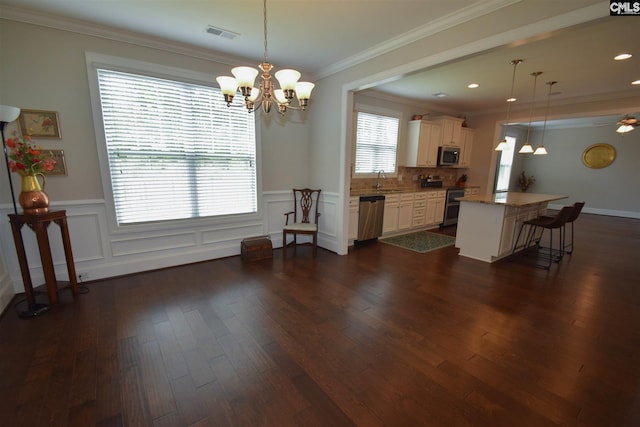 kitchen featuring backsplash, hanging light fixtures, and dark wood-type flooring