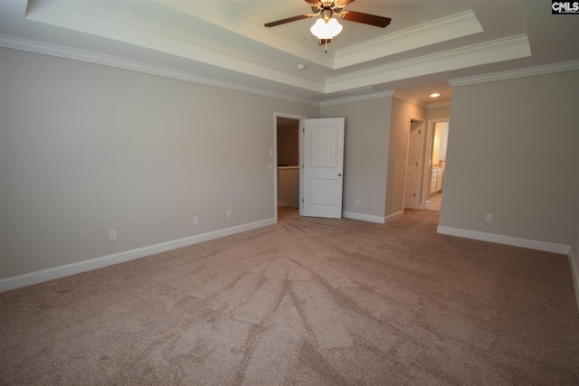 unfurnished bedroom featuring light carpet, a tray ceiling, ceiling fan, and crown molding