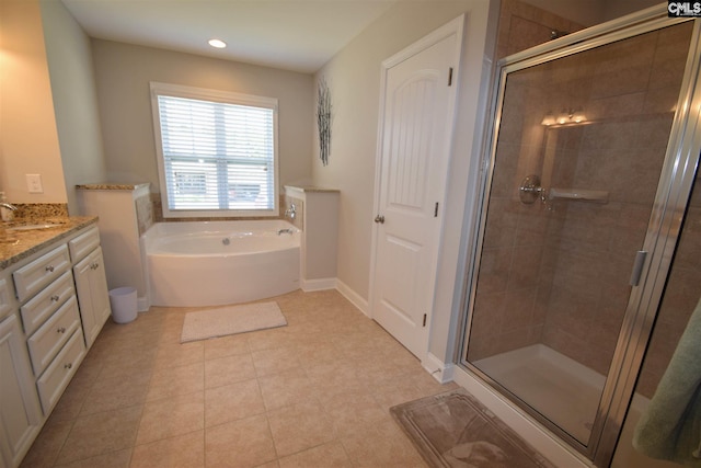 bathroom featuring tile flooring, shower with separate bathtub, and vanity