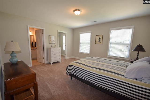 carpeted bedroom featuring connected bathroom