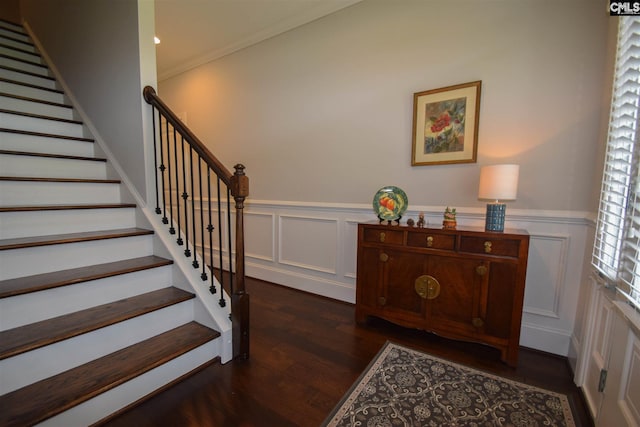 stairs featuring crown molding and dark wood-type flooring