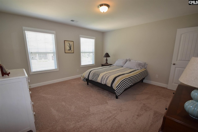 bedroom with light colored carpet