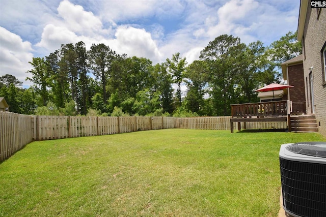 view of yard with a deck and central AC