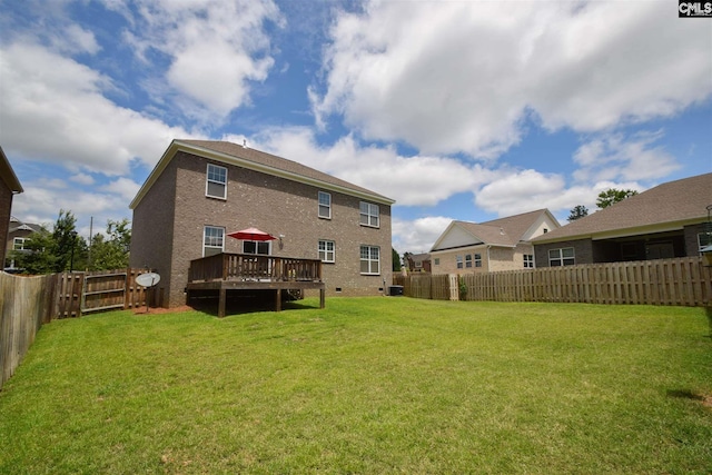 rear view of property featuring central AC unit, a wooden deck, and a yard