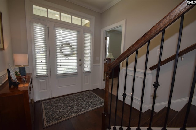 foyer entrance with crown molding, dark wood-type flooring, and a healthy amount of sunlight