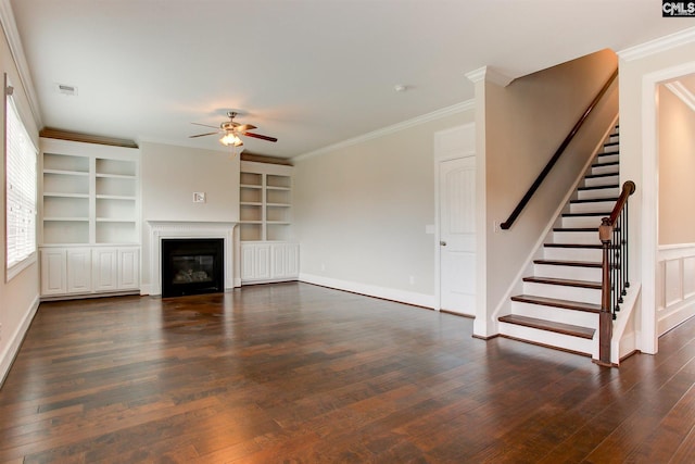 unfurnished living room with dark hardwood / wood-style flooring, ceiling fan, built in shelves, and ornamental molding