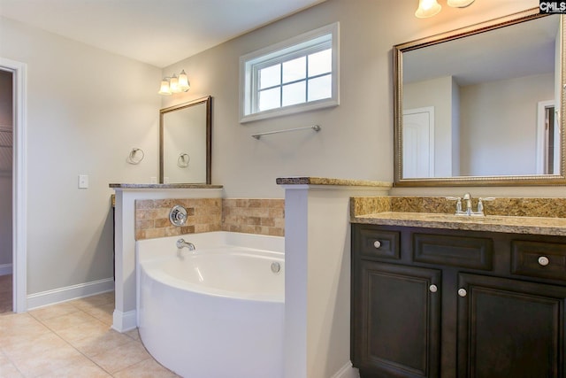 bathroom featuring vanity, a bath to relax in, and tile flooring