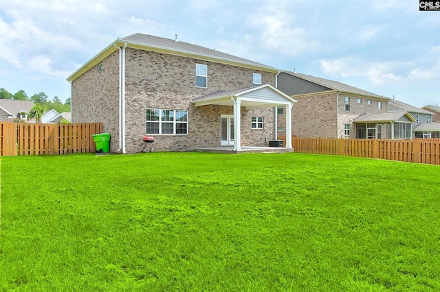 rear view of house with central air condition unit and a yard