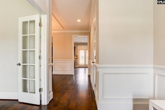 corridor with dark hardwood / wood-style floors and ornamental molding