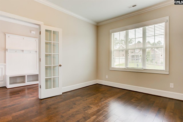 spare room featuring ornamental molding and dark hardwood / wood-style flooring