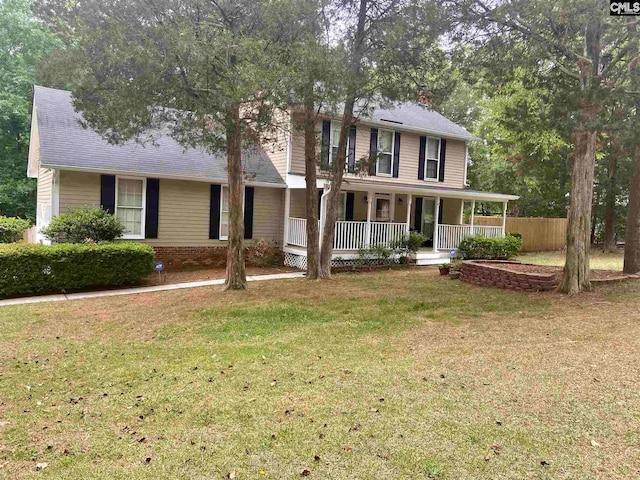 view of front of home with covered porch and a front lawn