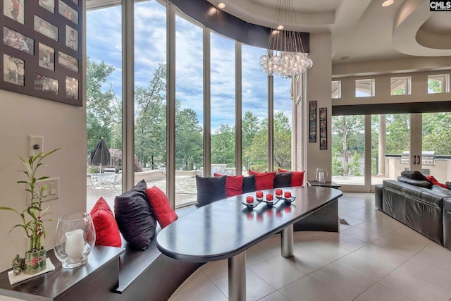 interior space featuring a tray ceiling and a chandelier