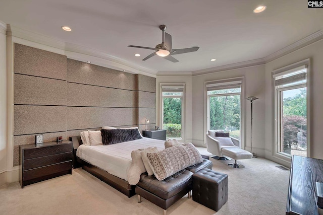 carpeted bedroom featuring ceiling fan and crown molding