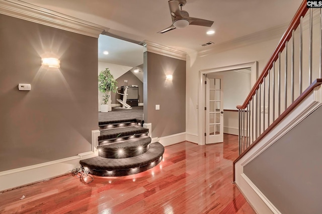 entrance foyer featuring ornamental molding, light hardwood / wood-style floors, and ceiling fan