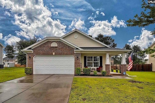 view of front of property featuring a porch, a front yard, and a garage