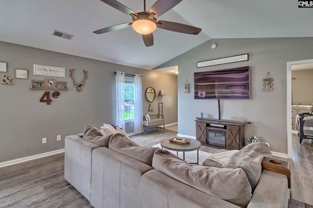 living room with lofted ceiling, ceiling fan, dark hardwood / wood-style flooring, and a fireplace