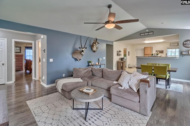 living room featuring lofted ceiling, a healthy amount of sunlight, ceiling fan, and hardwood / wood-style flooring